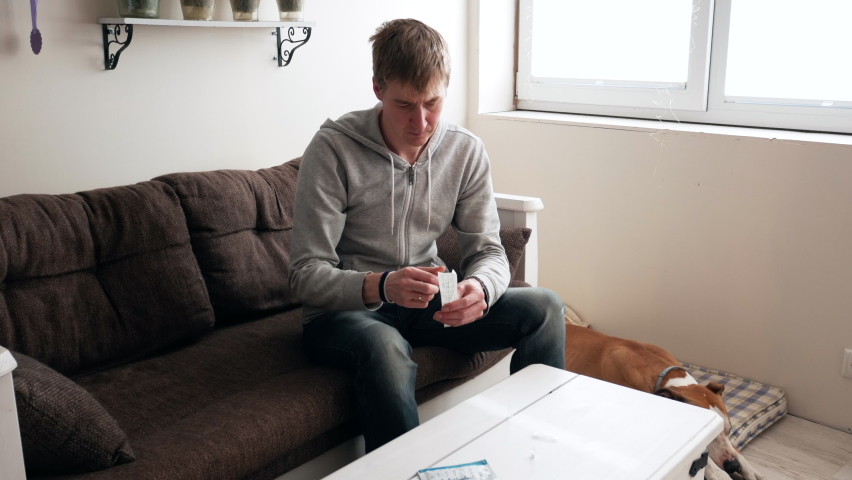 Man taking self-test for COVID-19 with the rapid home test kit. Coronavirus nasal swab test for infection. Royalty-Free Stock Footage #1070986246