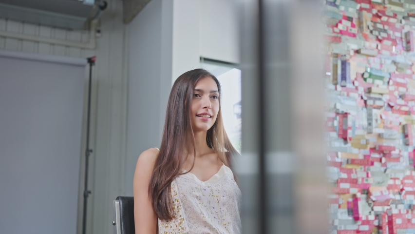 Caucasian beautiful woman customer taking photo by mobile phone, selfie after getting treatment service from hairdresser. Young attractive girl feel happy for new hair style at beauty salon or barber.