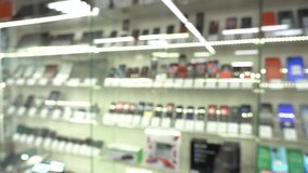 Shelf with new smartphones in a hardware store. Close-up. PAN. blurred video