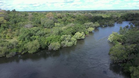 Aerial drone through a tributary of the Zambezi  river in flood through scenic 
pristine forests in Zambia