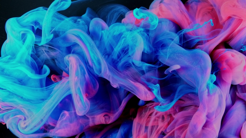 Magic mixing of color. Cloud of silky ink in water isolated on black background. Colorful ink in water, ink drop. Purple, blue, pink.