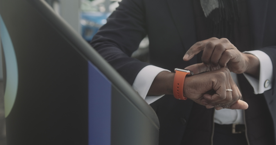 Close up of Business man using smart watch on console at electric charging station | Shutterstock HD Video #1071002755