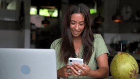 Happy hipster girl checking smartphone notification surprised with high speed internet connection for installing app, emotional female blogger reading funny content publication in social media
