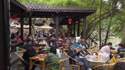 Chengdu, China - April 11, 2021: People drinking tea in People's Park at weekend in spring.