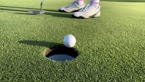 Putting a Golf Ball into a Hole - Powered by Shutterstock - Get 15% off with code: PIKWIZARD15