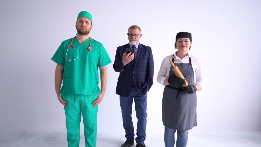 Portrait of three people of different professions and occupations standing side by side on a white background. Businessman, doctor and cook in uniform
