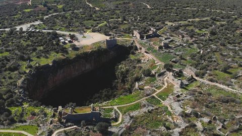 Aerial drone view of Ruins of Kanlıdivane, the ancient city of Kanytelis. Swallow Hole Olive Oil and History Canytelis, its ancient name (kanlidivane archaeological site) in Erdemli, Mersin, Turkey.