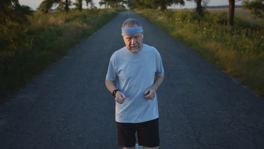 Old male sportsman running using latest innovative technology smart watch with augmented reality hologram, checking life system status. Future sport and healthcare concep, immersive digital technology Royalty-Free Stock Footage #1071022705