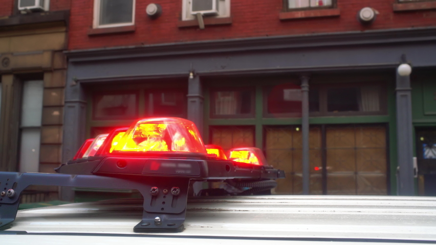 Alarm flashes or police siren lights. The patrol checks the city district during the day. Policemen patrol the streets of New York City.