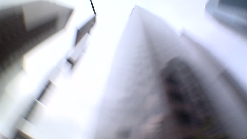 This is a looping shot looking directly up at towering skyscrapers spinning. 