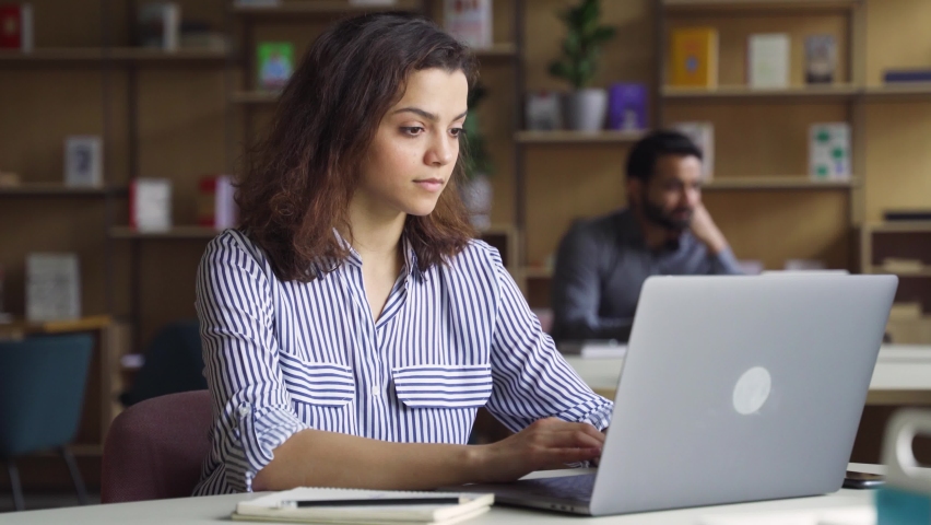 Hispanic latin girl college student using laptop computer watching distance online learning seminar class, remote university webinar or having virtual classroom meeting in university creative space. Royalty-Free Stock Footage #1071028873