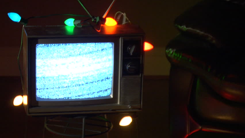 Retro TV surrounded by Christmas lights.