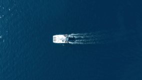 Croatia. Aerial view of luxury floating boat on blue Adriatic sea at sunny day. Fast boat on the sea surface. Seascape from drone. Travel video