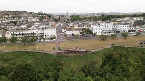 Aerial panning shot of beautiful historic city named Torquay. Build on a mountain bordering Atlantic ocean in England.