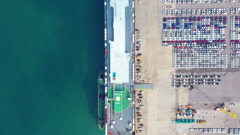 Aerial view Ro-Ro Ship of business logistic sea freight, New Cars produced by year up in the port for Cargo ship and Cargo import-export around in the world. cargo ship. 4K 