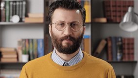 Sorry, man is apologizing and regret. Sad bearded male teacher or businessman with glasses looking at camera and sincerely apologizes and says Sorry. Slow motion