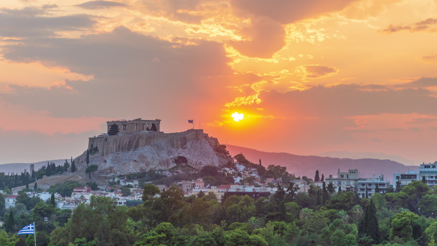 Scenic View Of The Acropolis Of Athens In Greece With Greek Flag Waving In Glorious Golden Hour Sunset. wide shot, time lapse