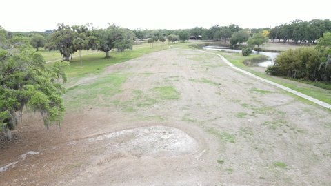 putting green and sand trap after golf course is abandoned in South Florida