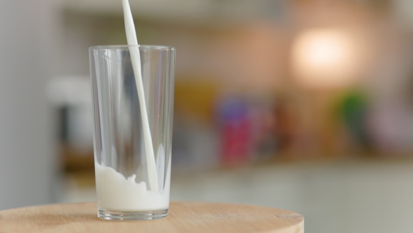 Milk Poured Into A Transparent Glass The Camera Moves Around | Shutterstock HD Video #1071078748
