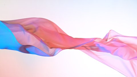 Pastel color transparent silk fabric flowing by wind, super slow motion