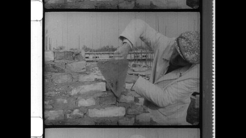 1950s Berlin, Germany. Post War Brick Layers building New Construction in West Berlin during the Cold War. 4K Overscan of Archival 16mm Film Print