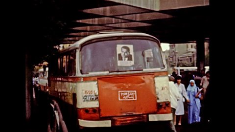Cairo, EGYPT, AFRICA - circa 1981: Egyptian public bus at the bus stop of Tahrir Square with the political poster of Mubarak president. Historical archival of Egypt in the 1980s.