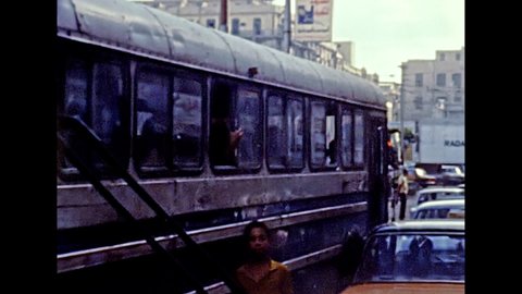 Alexandria, EGYPT, AFRICA - circa 1981: Egyptian public transport bus and vintage cars in traffic of Alexandria city. Historical archival of Egypt in the 1980s.