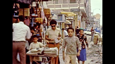 Alexandria, EGYPT, AFRICA - circa 1981: Egyptian bazaar in Alexandria city. Vintage cars and egyptian people on the streets of Alexandria. Historical archival of Egypt in 1980s.