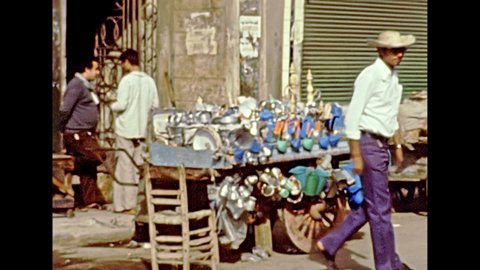 Alexandria, EGYPT, AFRICA - circa 1981: Egyptian bazaar in Alexandria city. Vintage cars and egyptian people on the streets of Alexandria. Historical archival of Egypt in 1980s.