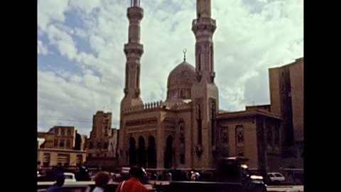 Alexandria, EGYPT, AFRICA - circa 1981: Ibn Khaldun mosque with vintage cars in traffic street of the Alexandria city. Historical archival of Egypt in the 1980s.