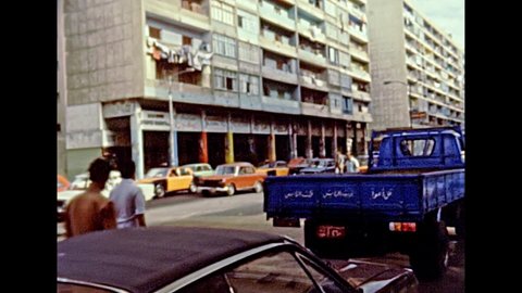 Alexandria, EGYPT, AFRICA - circa 1981: Egyptian people on roads of of the Alexandria city. Vintage cars in traffic. Historical archival of Egypt in the 1980s.