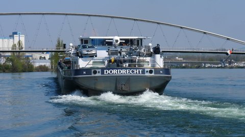 freight ship Dordrecht leaving Basel harbor at famous bridge Dreiländerbrücke, CH Switzerland. 21th April 2021