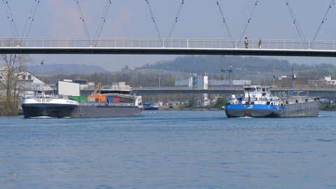 freight ship Wielingen and Gitte at famous bridge Dreiländerbrücke in Basel, CH Switzerland. 21th April 2021