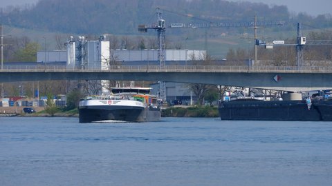 freight ship Wielingen at famous bridge Dreiländerbrücke in Basel, CH Switzerland. 21th April 2021