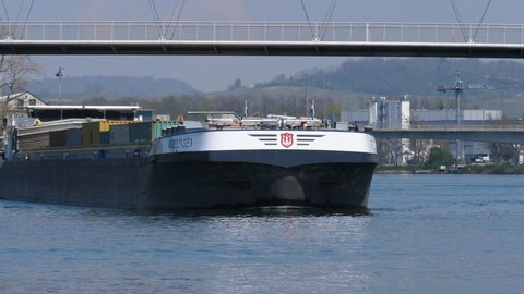 freight ship Wielingen arriving at famous bridge Dreiländerbrücke in Basel, CH Switzerland. 21th April 2021