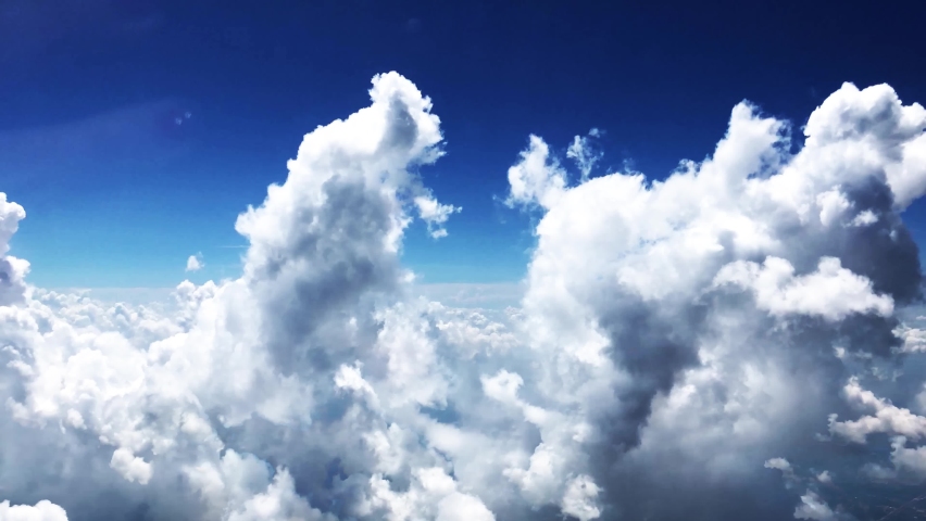 Blue sky white clouds. Puffy fluffy white clouds. Cumulus cloud scape timelapse. Summer blue sky time lapse. Dramatic majestic amazing blue sky. Soft white clouds form. Cloud time lapse background .	