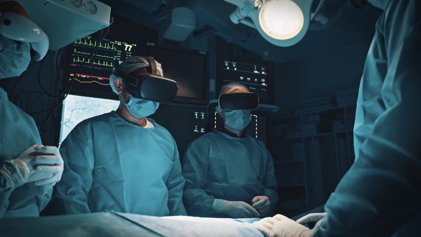 Surgeons examine patient organ using augmented reality holographic headsets. Doctor analysis health status interacting with virtual interface. Animation of digital liver appearance. Future medicine Royalty-Free Stock Footage #1071095128