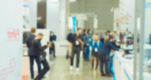 Modern city life. Abstract blurred background on business theme. Blurry defocused video. Unrecognizable people in a large modern building.