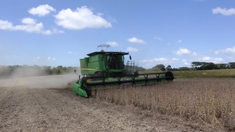 Sinop, Mato Grosso, Brazil, April 12, 2018: Modern soybean harvester harvesting soybeans in a farm field. Machine with John Deere technology. Concept of agriculture, food industry, business.