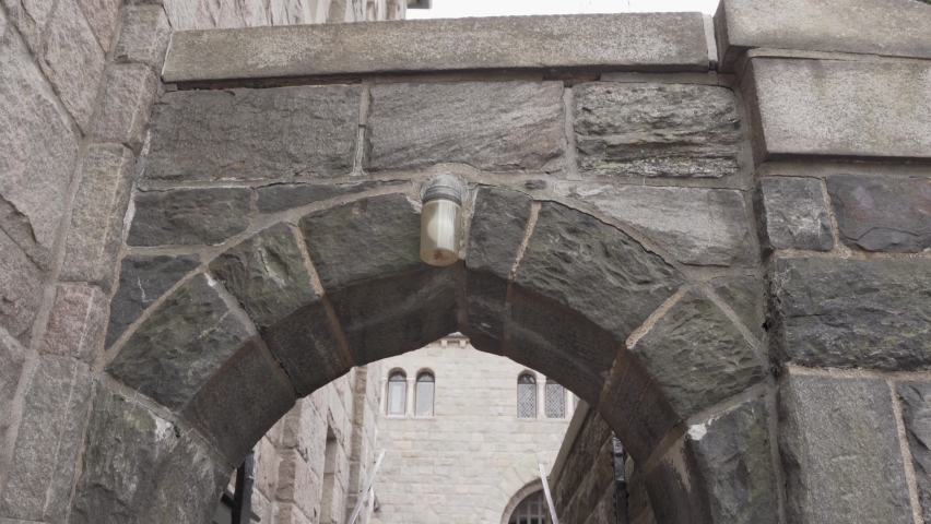 Stairs under ancient stone arch in The Cloisters, New York. Handheld shot
