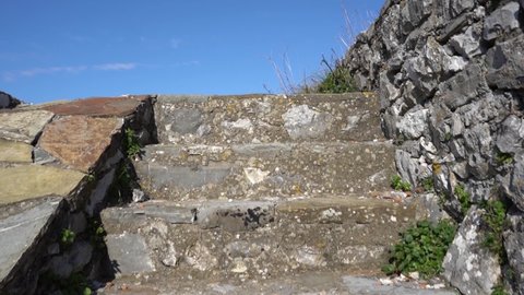 Climbing stone stairs of medieval fortress, ascending slowly to heaven