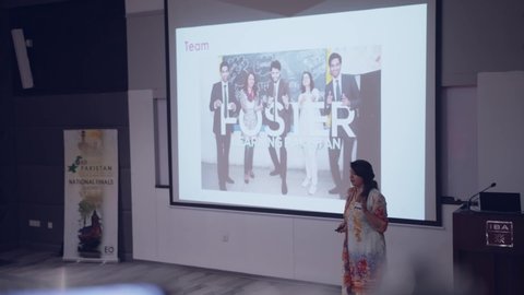 Unique shot shows focus shifting from the camera screen to the female entrepreneur candidate presenting on stage. Karachi, Pakistan. 15th Dec 2018