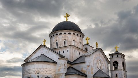Christian church time lapse under dramatic sky. Dome and crosses on an orthodox cathedral. Religious temple - place of worship of Jesus against fast moving clouds. Resurrection of Christ in Podgorica.