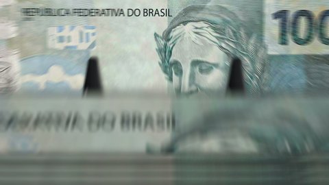 Money counting machine with Brazilian Real banknotes. Business, economy, banking and finance in Brazil. Abstract concept loopable and seamless animation. Fast BRL currency rotation.