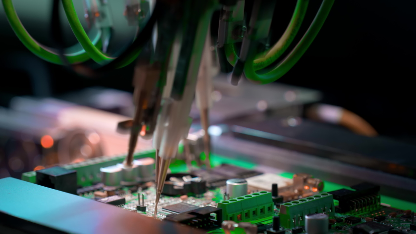 Machine for automatic testing of electronic boards. Manufacturing of microcircuits and microprocessors. Transistors are installed on a green board. The needles touch the microcircuit. Royalty-Free Stock Footage #1071140056