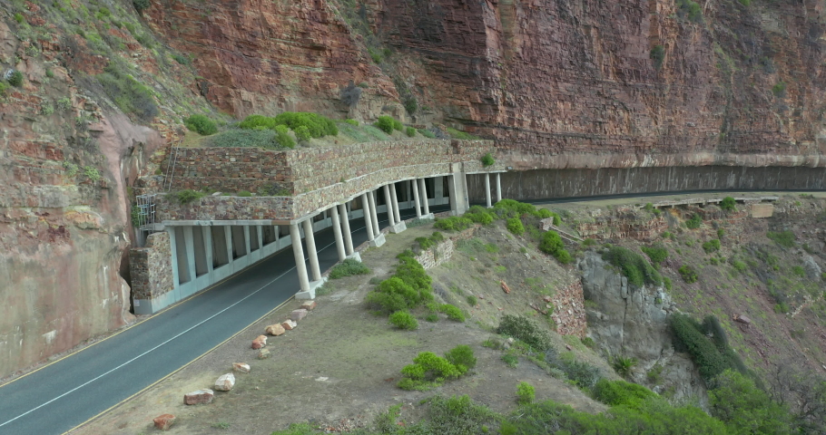 Aerial view. Chapmans Peak Drive near Cape Town, South Africa. Top view of road going through beautiful landscape. Road bending along the ocean.