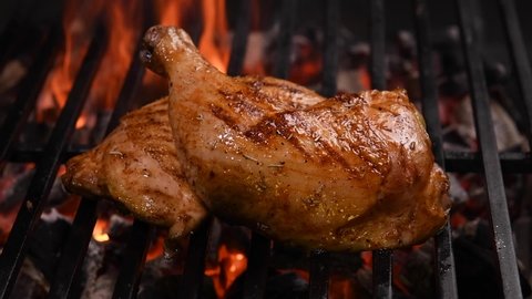 Grilled chicken thigh on the flaming grill