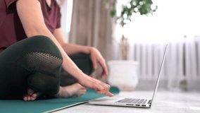 Online Home Training. Slim Woman Practicing Yoga At Laptop Watching Videos Sitting In Lotus Position Indoors