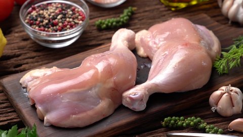 Fresh chicken thighs without skin on a cutting board