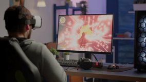 Videogamer losing graphics cyberspace video game sitting on gaming chair using wireless controller and VR headset playing on powerful computer. Sad pro cyber man streaming online championship